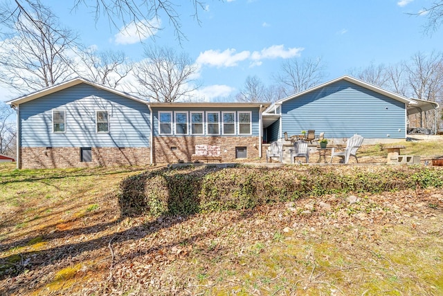 rear view of property with stone siding