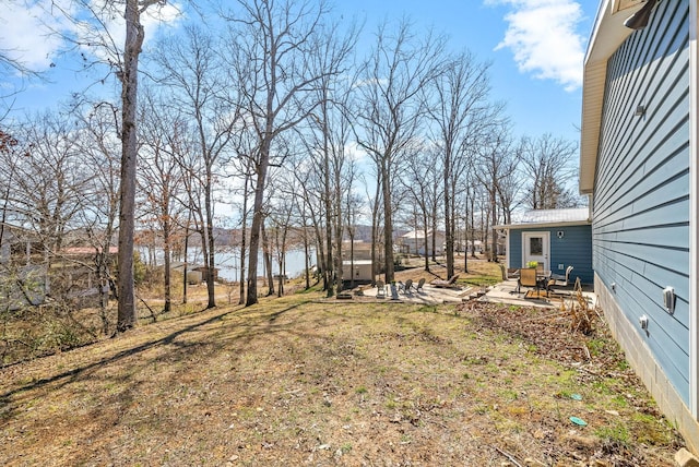 view of yard with a patio area and a water view