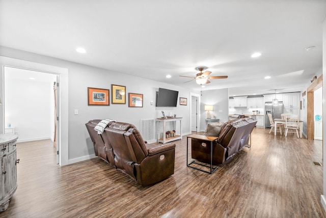 living room featuring a ceiling fan, recessed lighting, and wood finished floors