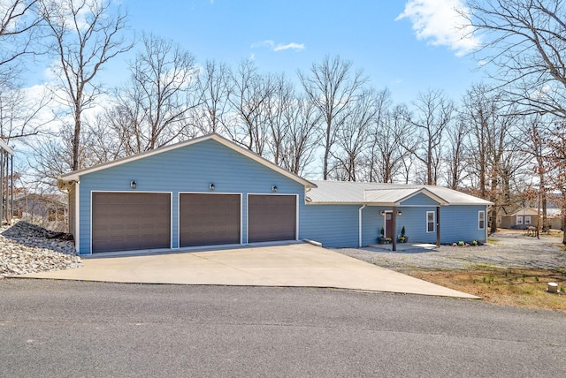 view of front of home with metal roof and a garage