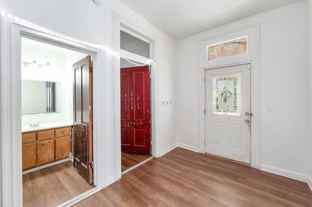 entrance foyer with baseboards and light wood-style floors