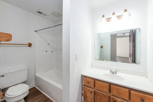 full bathroom with visible vents, toilet, wood finished floors, vanity, and  shower combination