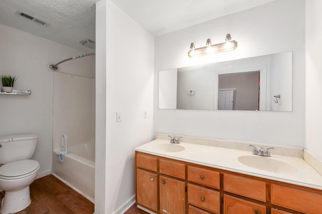 bathroom with double vanity, toilet, visible vents, and a sink