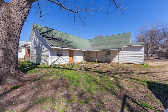 rear view of house with a yard