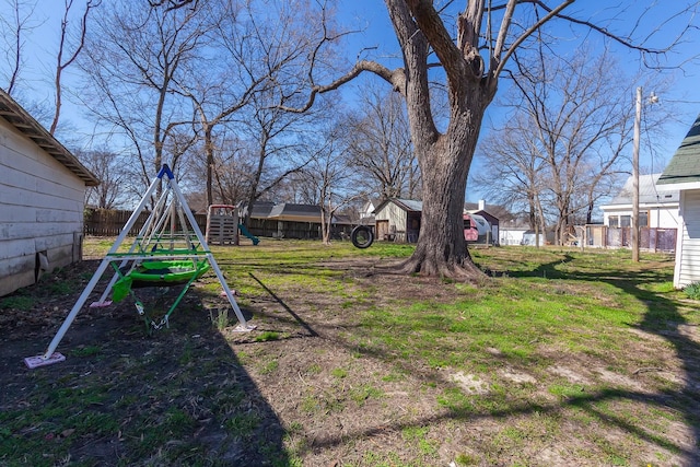 view of yard with a playground and fence