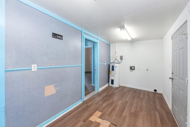 interior space with wood finished floors, water heater, and baseboards