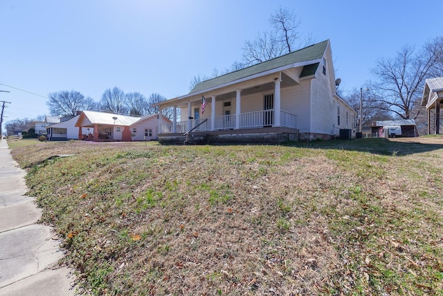 view of front of property with covered porch and a front lawn