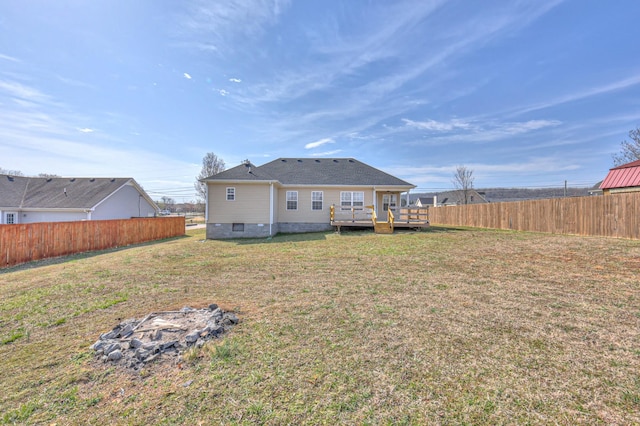 back of house featuring a deck, fence, a lawn, and crawl space