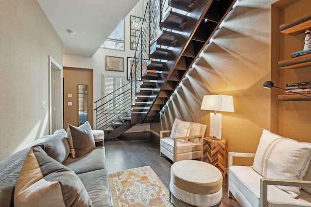 living room with stairs and wood finished floors