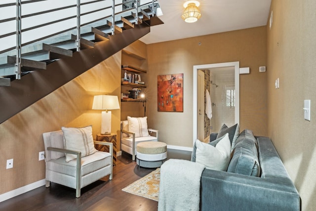 living area featuring stairway, baseboards, and wood finished floors