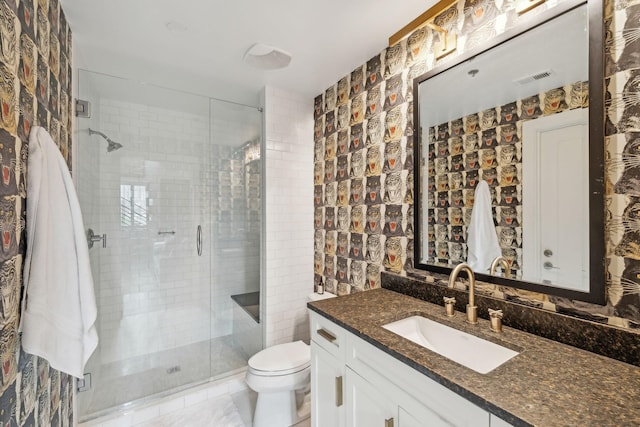 bathroom featuring vanity, a shower stall, toilet, and visible vents