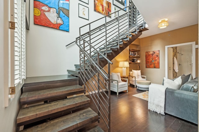 stairway with a wealth of natural light and wood finished floors