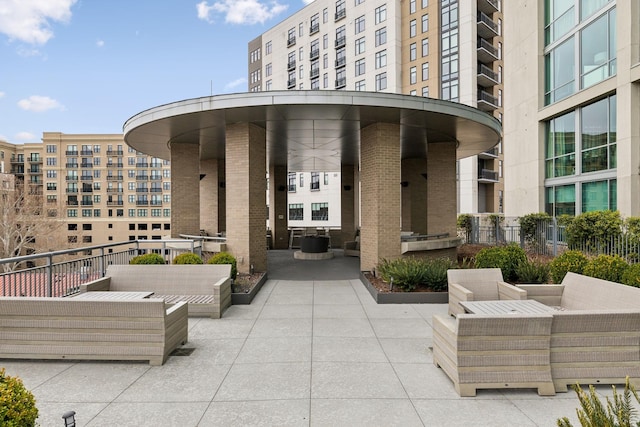 surrounding community featuring an outdoor living space and a patio