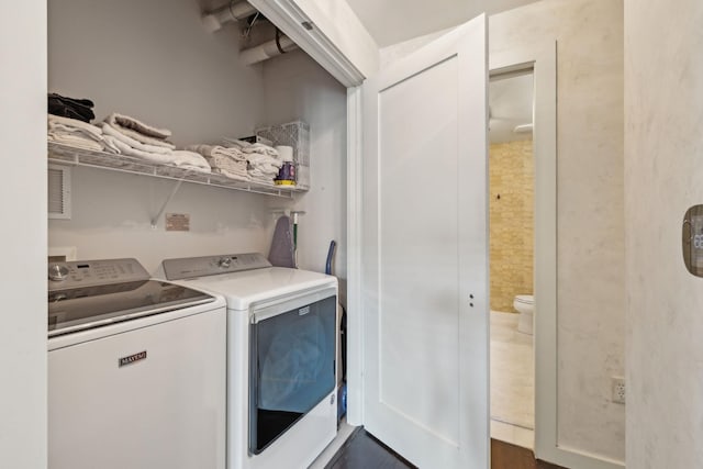 washroom featuring laundry area and washer and dryer