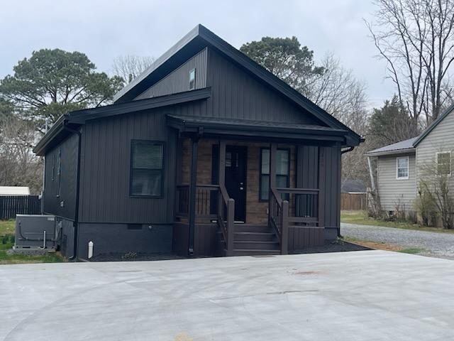 bungalow-style house featuring central AC unit and covered porch