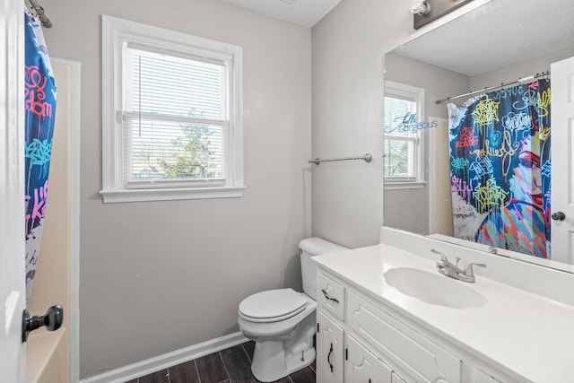 bathroom with vanity, a shower with shower curtain, wood finished floors, baseboards, and toilet