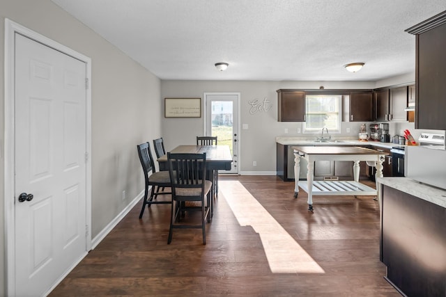 dining room with baseboards, a textured ceiling, and dark wood-style flooring