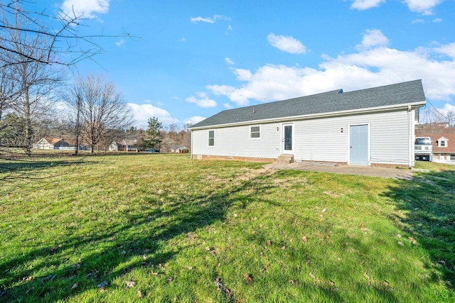 rear view of property with a lawn