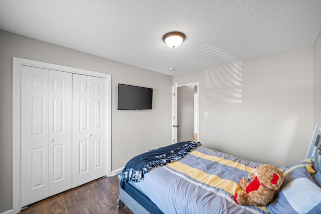 bedroom with a closet, a textured ceiling, and wood finished floors