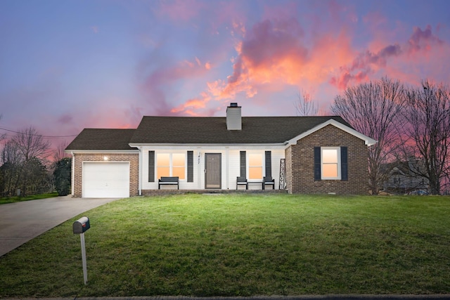 ranch-style house featuring driveway, a front yard, a garage, brick siding, and a chimney