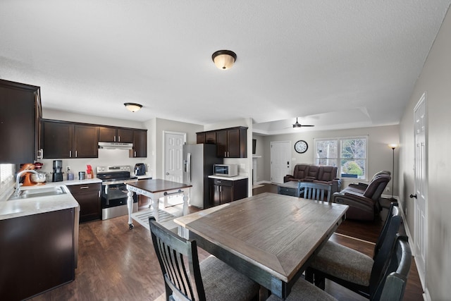 dining space featuring dark wood-type flooring and ceiling fan