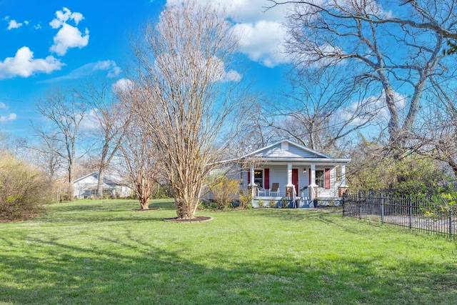 view of front facade with a porch, a front yard, and fence