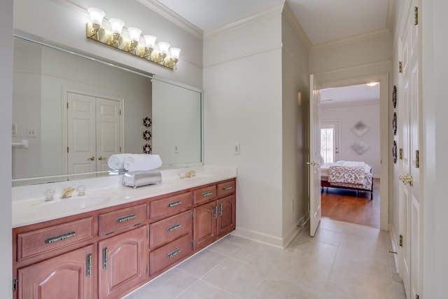 bathroom with a sink, double vanity, tile patterned flooring, and ornamental molding