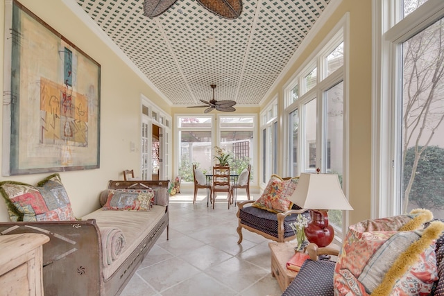 sunroom / solarium featuring a ceiling fan