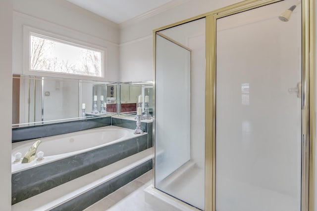 bathroom with a stall shower, a garden tub, and ornamental molding