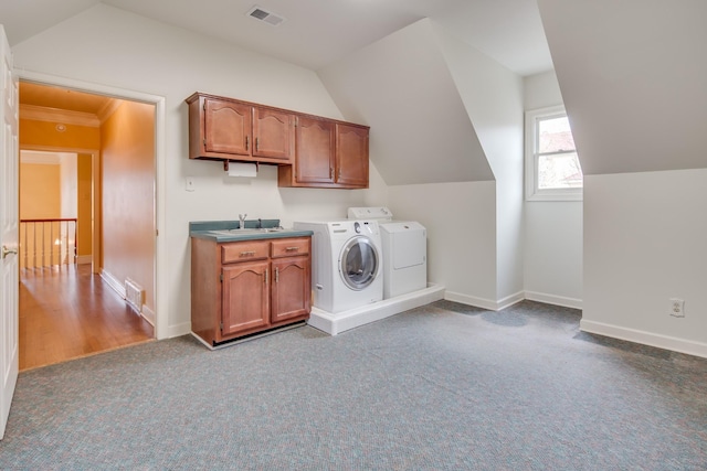 clothes washing area with washing machine and clothes dryer, visible vents, carpet flooring, and baseboards