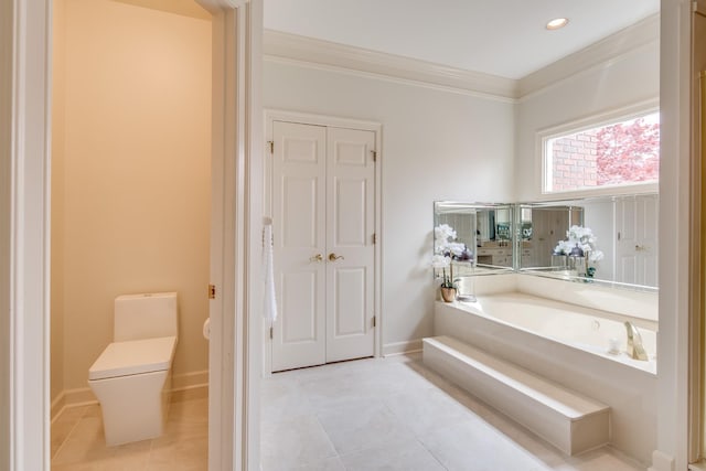 full bathroom featuring tile patterned flooring, crown molding, baseboards, toilet, and a bath