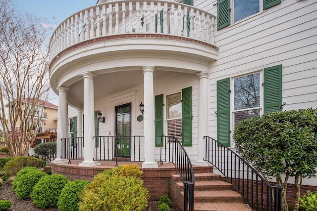 view of exterior entry featuring covered porch