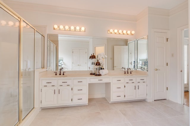 bathroom with tile patterned flooring, a shower stall, crown molding, double vanity, and a sink