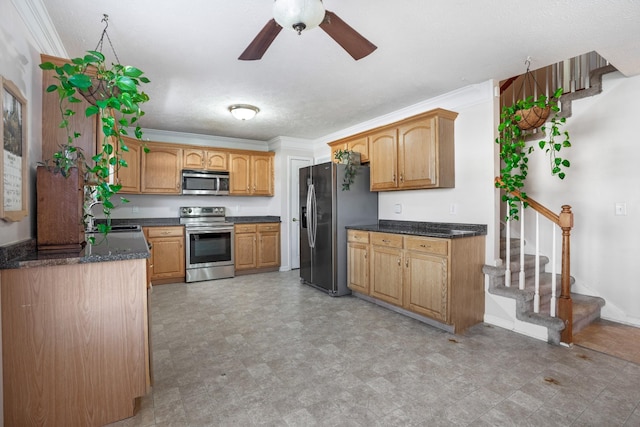 kitchen with a ceiling fan, baseboards, a sink, appliances with stainless steel finishes, and crown molding