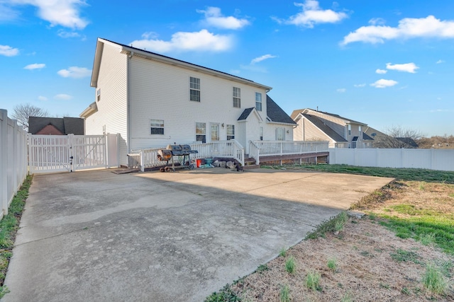 rear view of property with fence and a gate