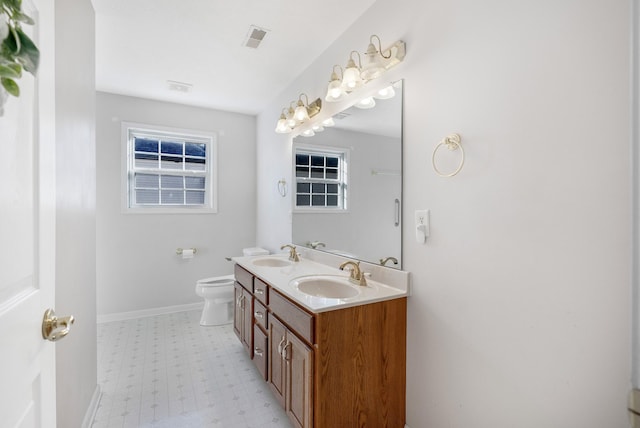 full bath featuring visible vents, toilet, baseboards, and a sink