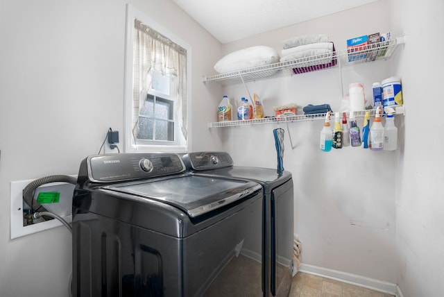 washroom with laundry area, baseboards, and separate washer and dryer