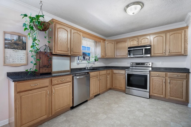 kitchen with a textured ceiling, crown molding, appliances with stainless steel finishes, and a sink