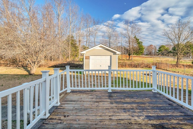 wooden deck with an outbuilding, a lawn, and a garage