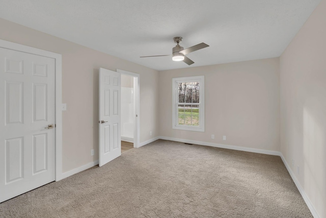 unfurnished bedroom featuring carpet flooring, baseboards, and ceiling fan