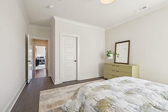 bedroom with baseboards, visible vents, wood-type flooring, and ornamental molding