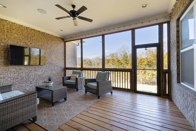 sunroom featuring ceiling fan