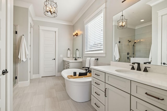 full bathroom featuring an inviting chandelier, crown molding, a shower stall, and a sink