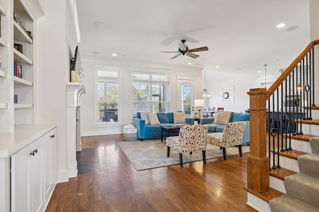 living room featuring stairway, plenty of natural light, and dark wood-style flooring