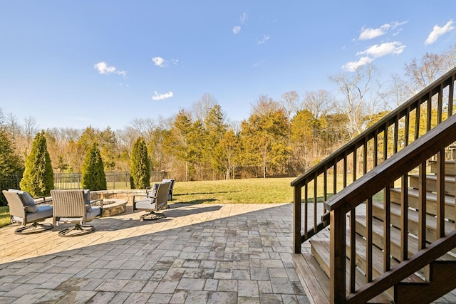 view of patio featuring a fire pit, stairs, and fence