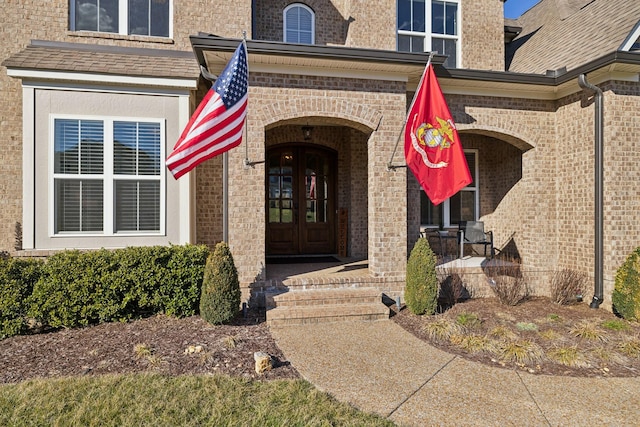 doorway to property with french doors and brick siding