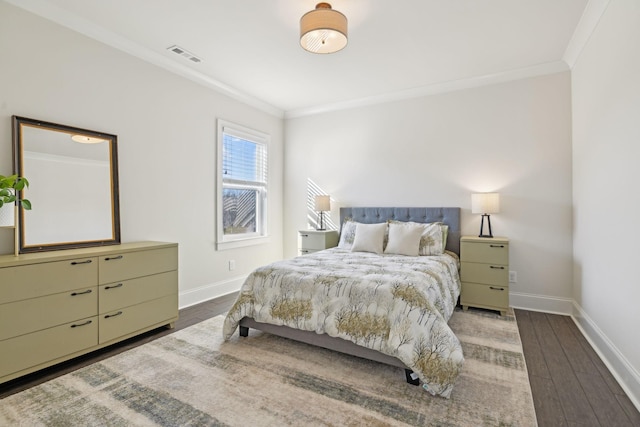 bedroom featuring wood finished floors, baseboards, and ornamental molding