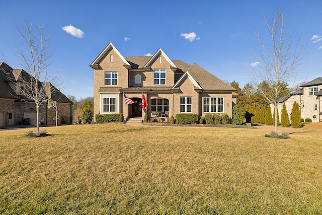 view of front of home featuring a front yard and brick siding