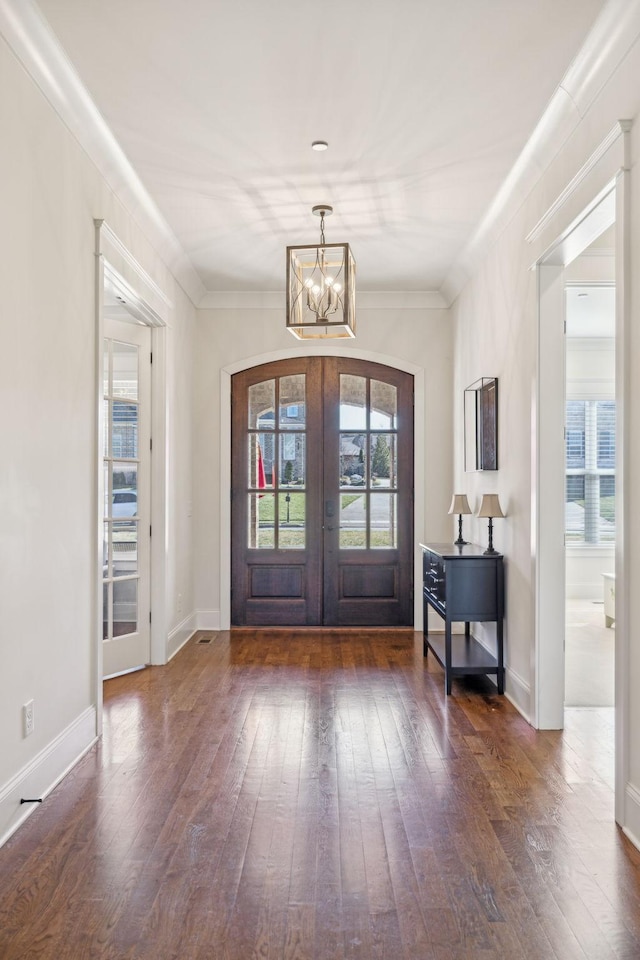 foyer with a wealth of natural light, french doors, and hardwood / wood-style flooring