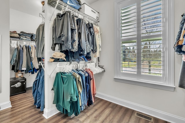 walk in closet featuring visible vents and wood finished floors